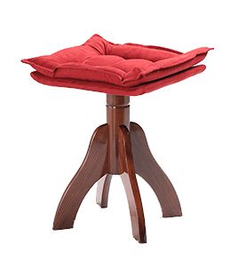A red cushion on top of a wooden stool.