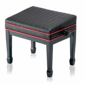 A black piano stool with red piping on top of it.