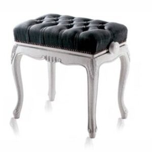 A black and white stool with a tufted seat.