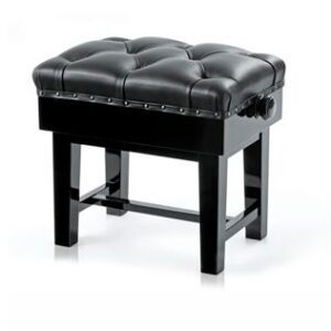 A black bench with a tufted top and wooden legs.