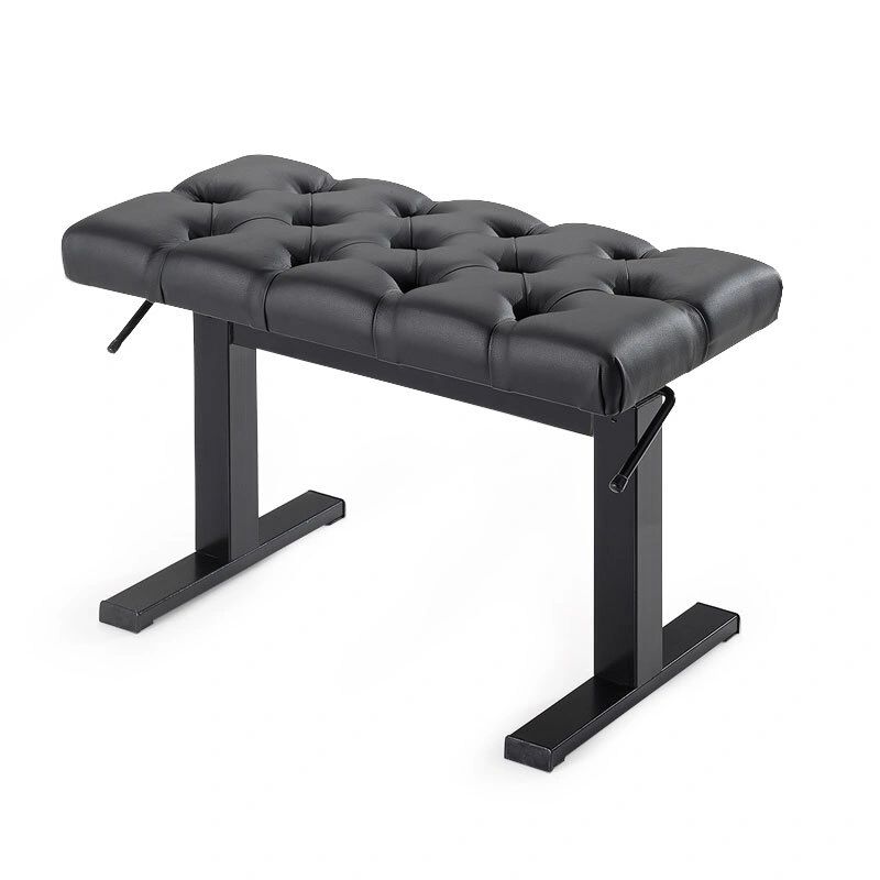 A black bench with a metal frame and a button tufted seat.