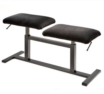 A black bench sitting on top of a metal stand.