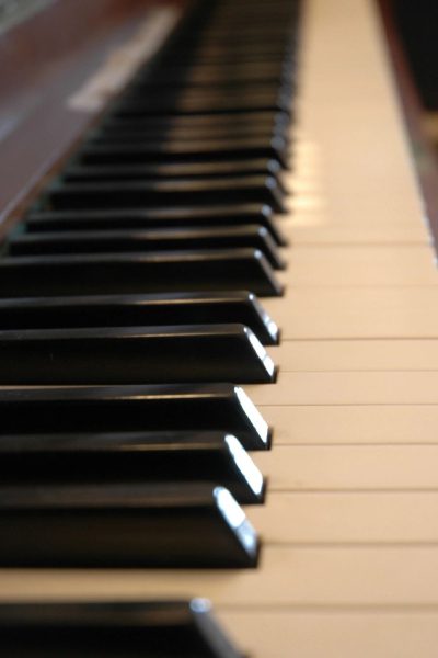 A close up of the keys on an old piano
